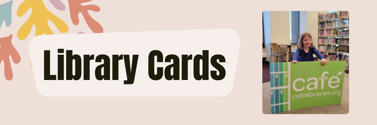 Young girl smiling and holding a large library card