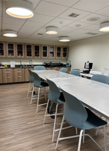 Makerspace room showing a long table with chairs