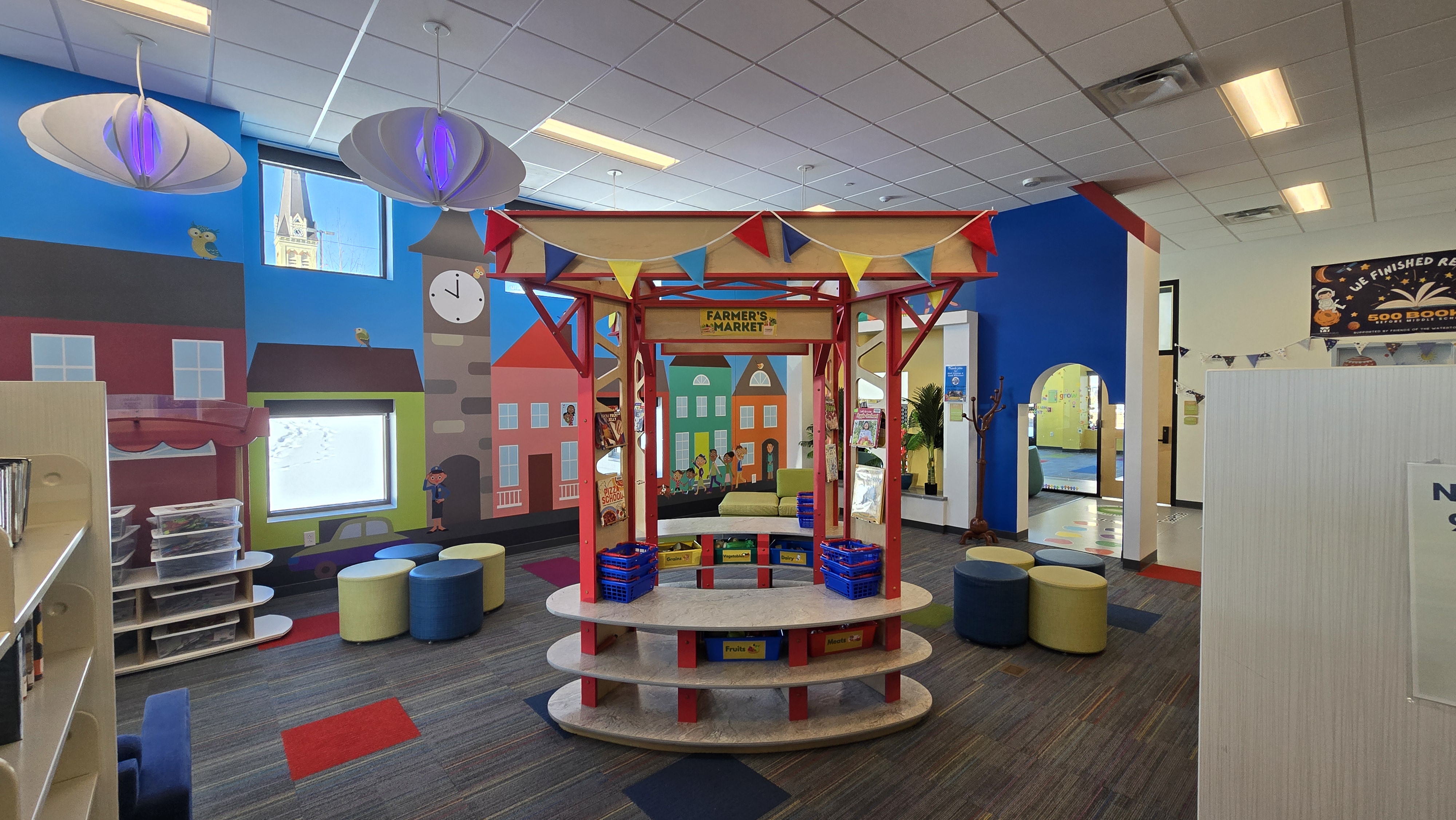 Marketplace structure in the center of a colorful children's library.
